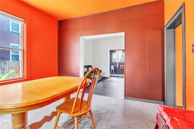 a dining room with furniture and a window