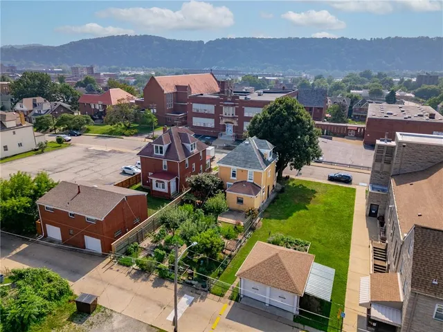 an aerial view of residential houses with outdoor space