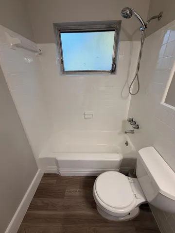a bathroom with a toilet and a shower