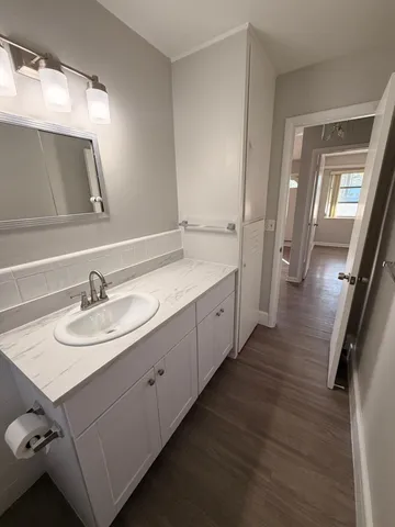 a bathroom with a double vanity sink and mirror