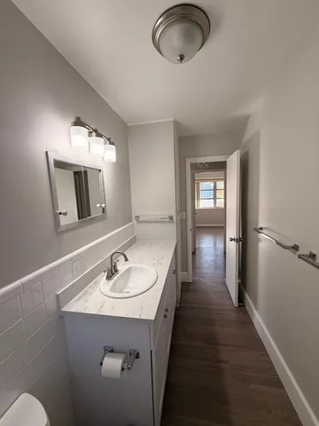 a en suite bathroom with a sink and a mirror