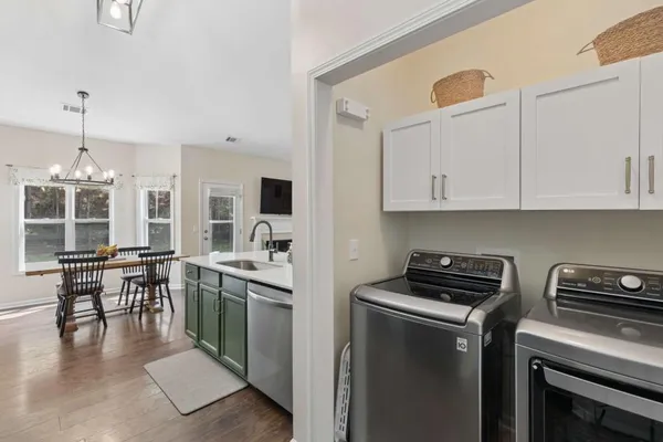 a kitchen that has a lot of cabinets in it and appliances