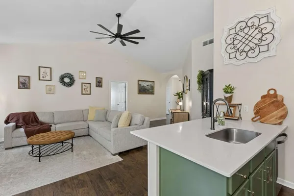 a living room with a sink and a table