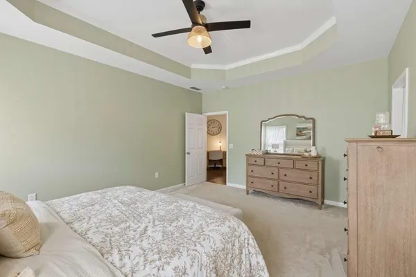 a bedroom with a bed dresser and a window