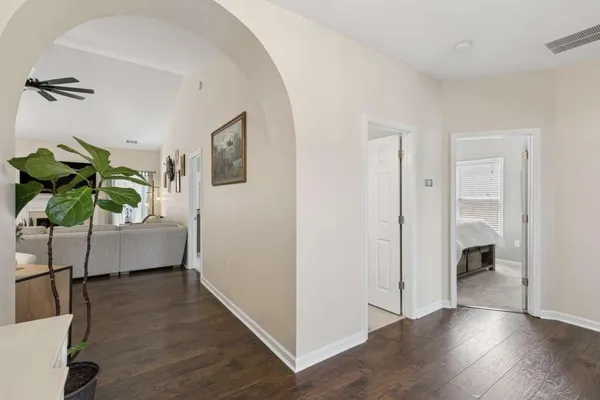 a view of livingroom with hallway and wooden floor