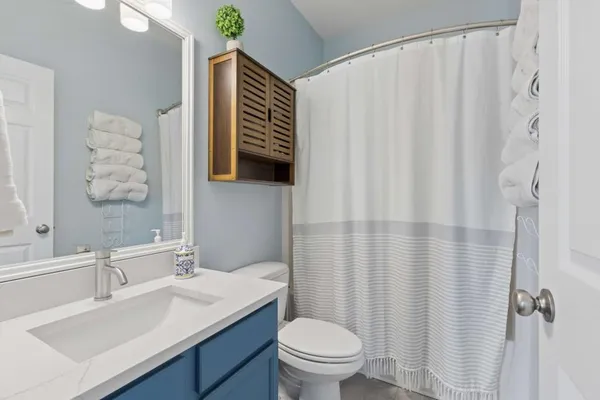 a bathroom with a sink toilet and shower