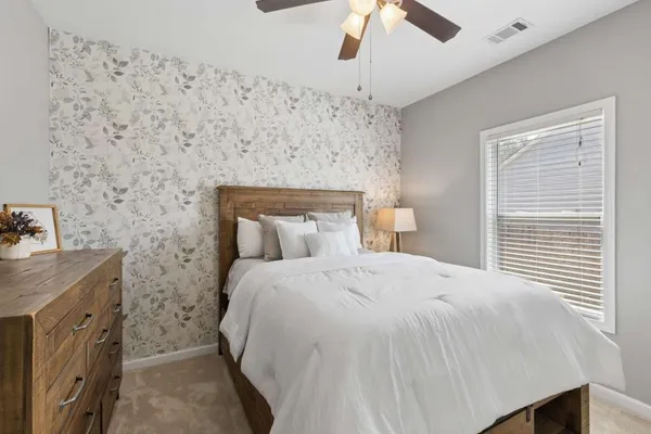 a bedroom with a bed and a chandelier