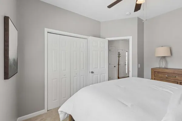 a bedroom with a bed and a night stand