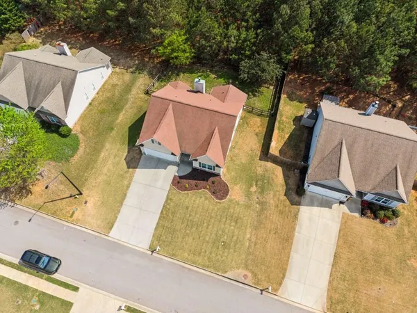 an aerial view of a house with swimming pool and porch