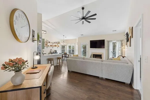 a living room with furniture a chandelier and a flat screen tv