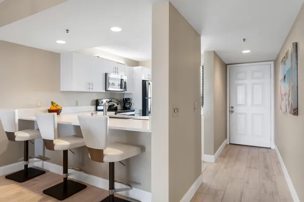 a view of a dining room with furniture and chandelier