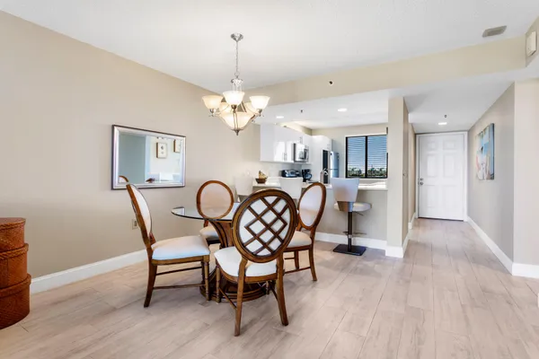 a living room with patio furniture and a chandelier