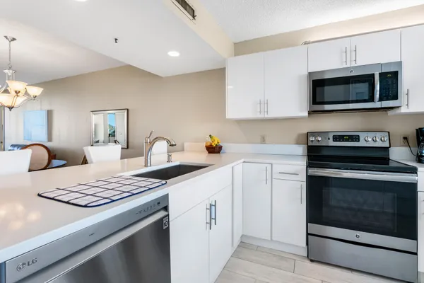 a kitchen with stainless steel appliances white cabinets and a refrigerator