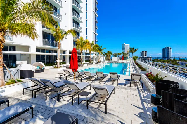 a view of a building with sitting area and furniture