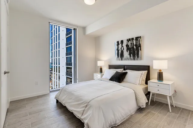 a bedroom with a bed and a window