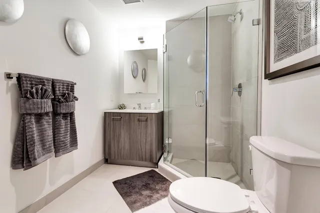 a bathroom with a toilet a sink and shower