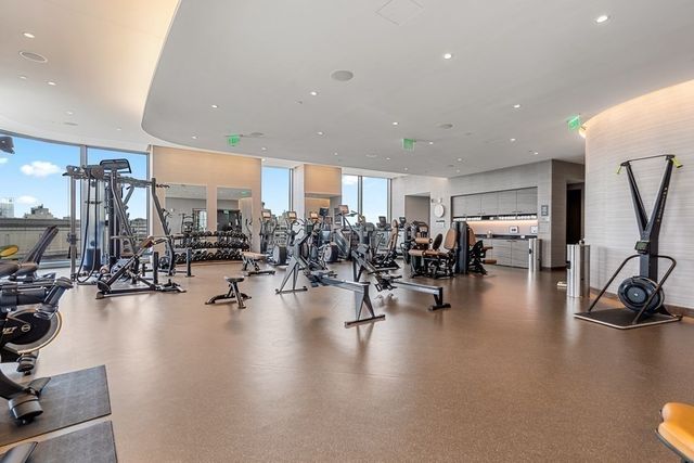 a view of a room with gym equipment and a large window