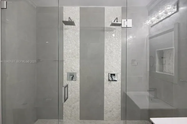 a bathroom with a mirror and a shower