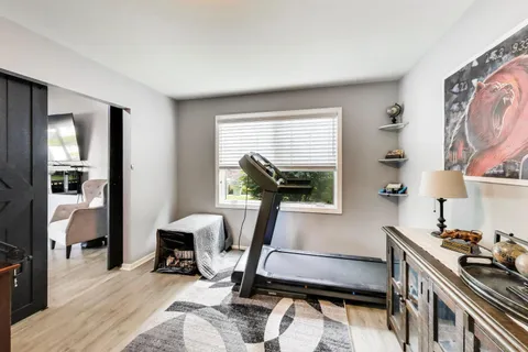 a kitchen with a sink cabinets and a wooden floor
