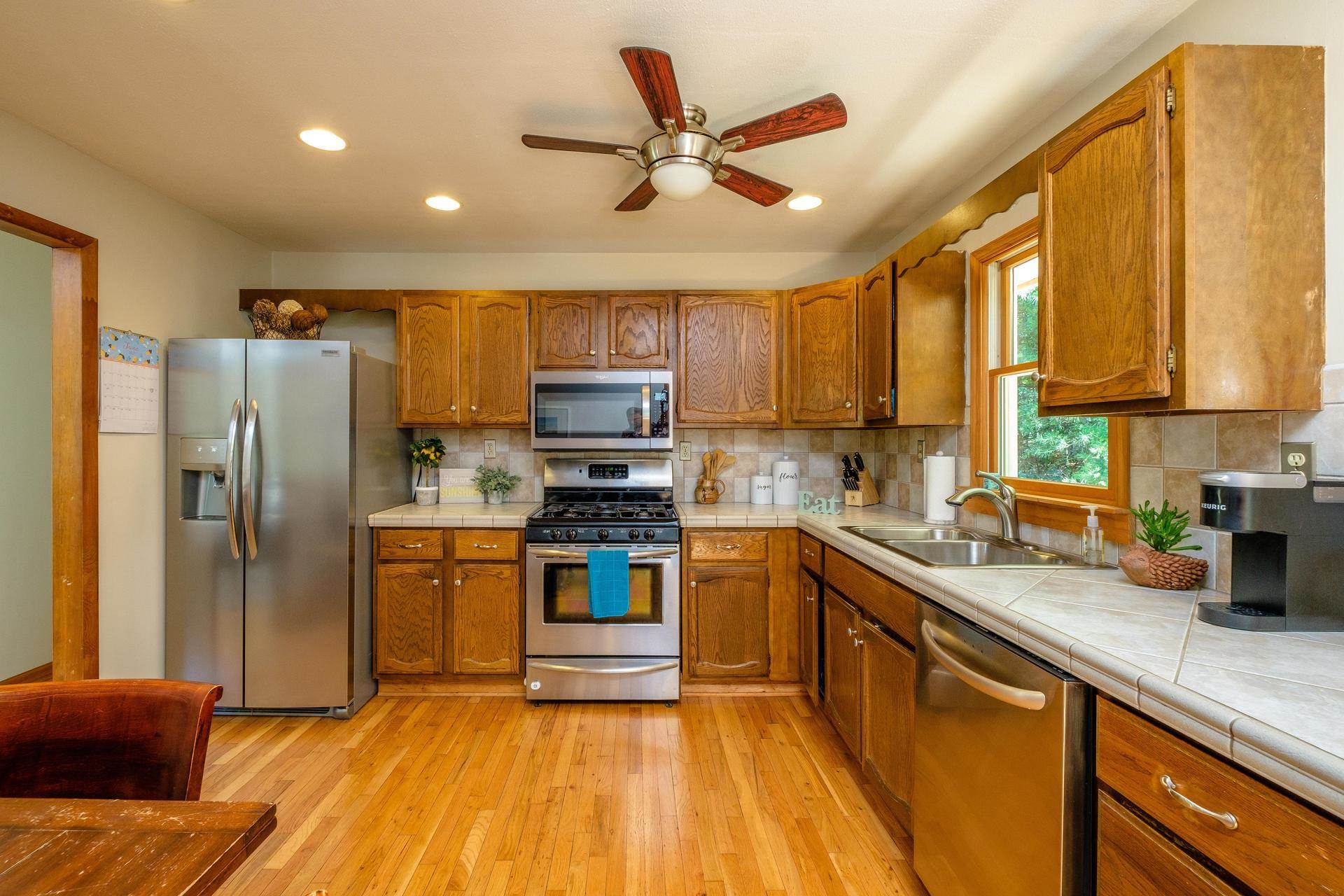 577 Union Church Road Churchville, VA 24421 - Photo 3 of 35 a kitchen with stainless steel appliances granite countertop a refrigerator a sink dishwasher a stove top oven a kitchen island and chairs with wooden floor