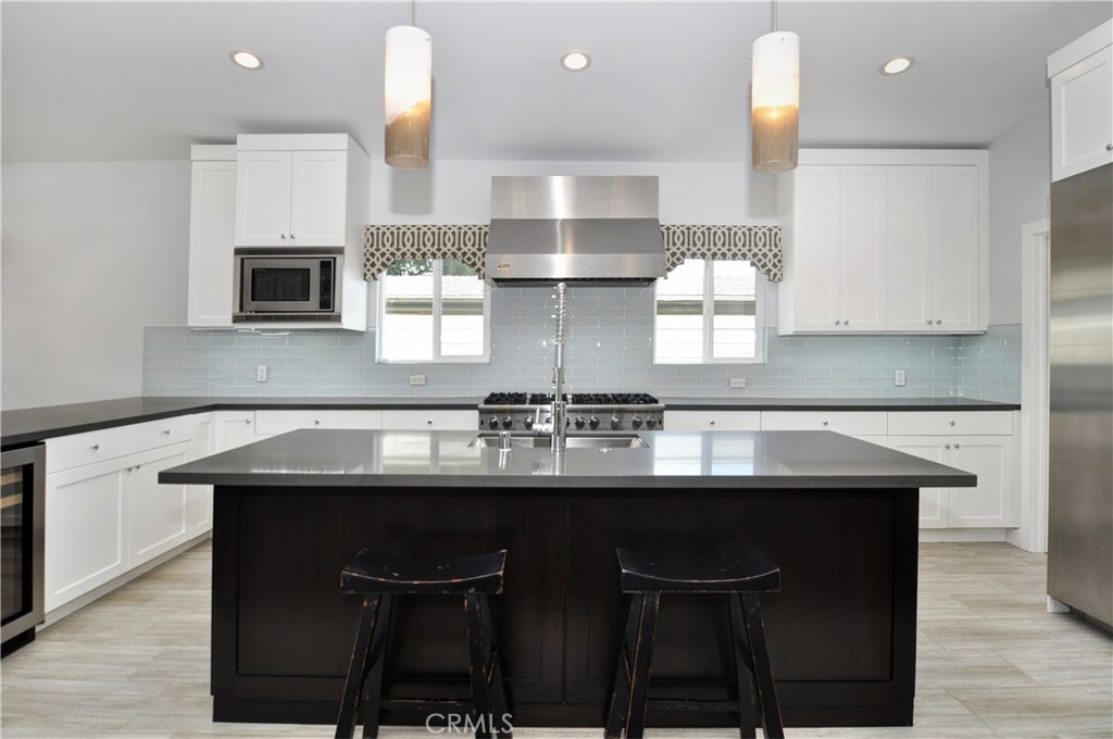 2339 Westminster Avenue Costa Mesa, CA 92627 - Photo 10 of 36 a kitchen with a sink and cabinets