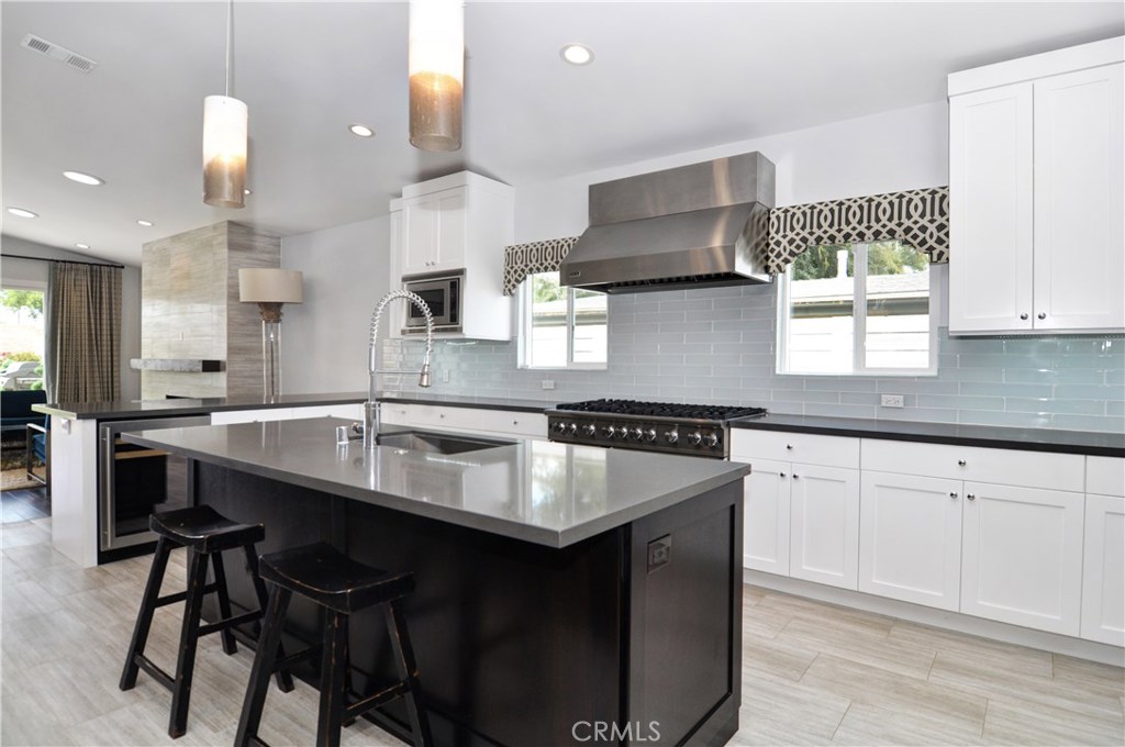 2339 Westminster Avenue Costa Mesa, CA 92627 - Photo 11 of 36 a kitchen with stainless steel appliances granite countertop a sink a stove and a wooden floors