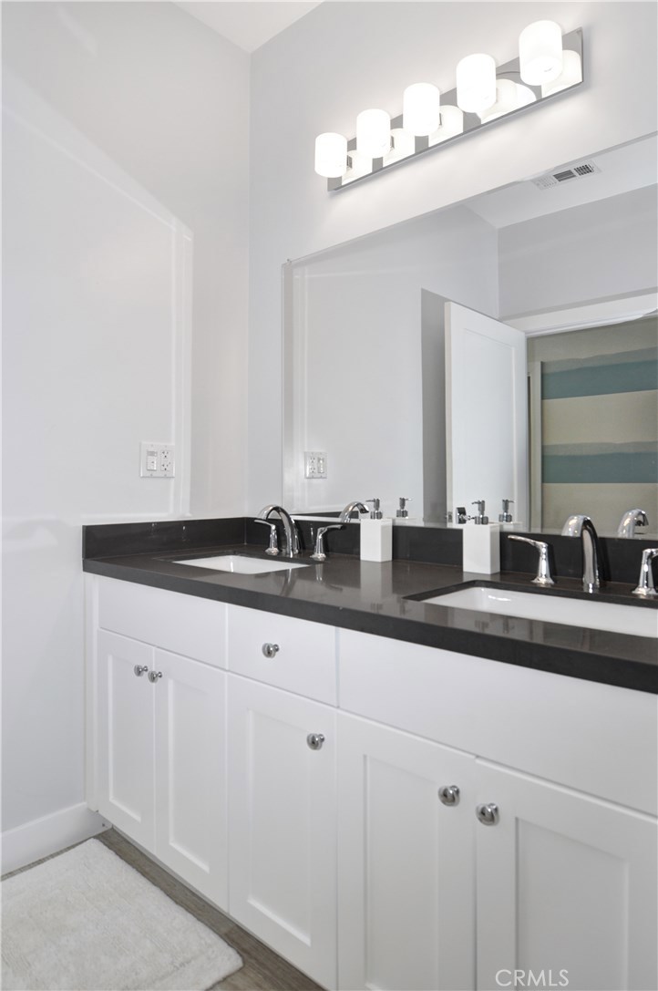 2339 Westminster Avenue Costa Mesa, CA 92627 - Photo 22 of 36 a bathroom with a sink and mirror