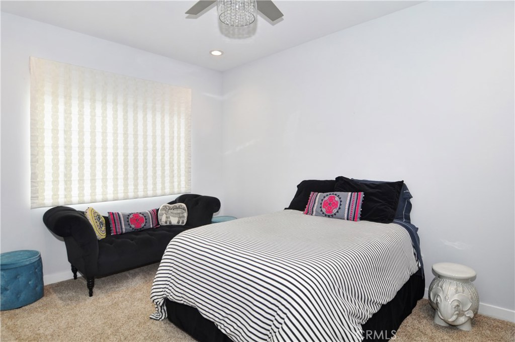2339 Westminster Avenue Costa Mesa, CA 92627 - Photo 23 of 36 a bedroom with a bed and wooden floor