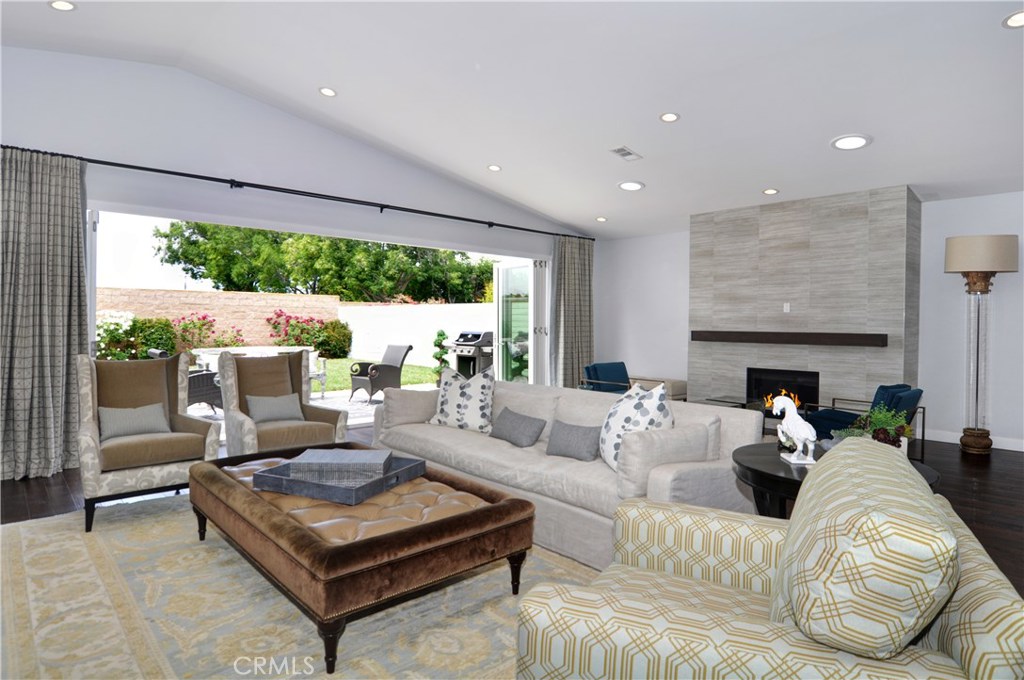 2339 Westminster Avenue Costa Mesa, CA 92627 - Photo 36 of 36 a living room with furniture a fireplace and a large window