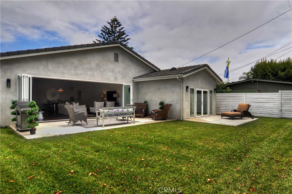 2339 Westminster Avenue Costa Mesa, CA 92627 - Photo 30 of 36 a view of a patio with table and chairs under an umbrella