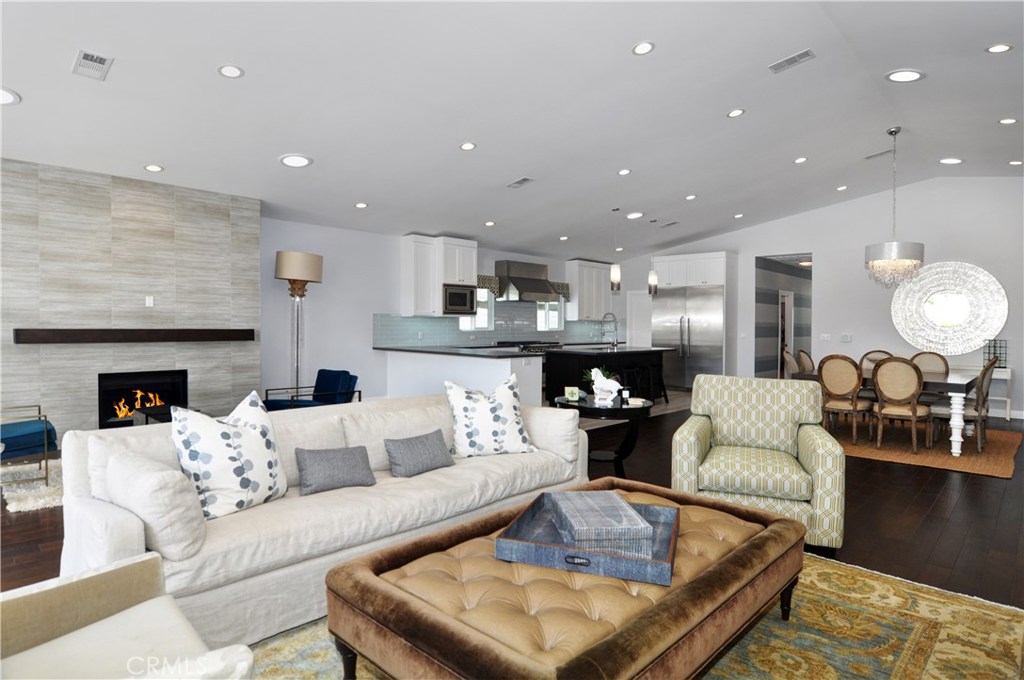 2339 Westminster Avenue Costa Mesa, CA 92627 - Photo 5 of 36 a living room with fireplace furniture and a wooden floor