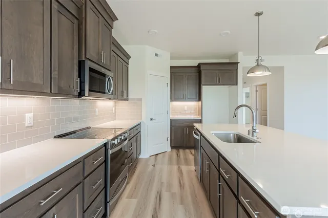 a view of empty room with wooden floor and fireplace