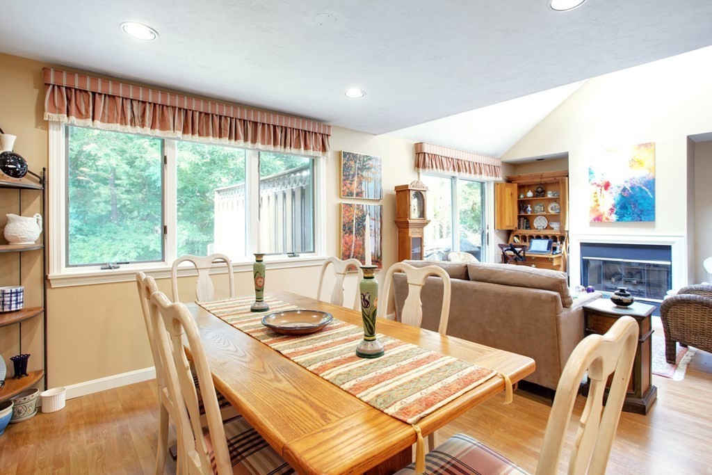 10 Kettle Lane, Unit 10 Mashpee, MA 02649 - Photo 11 of 31 a view of a dining room with furniture large windows and wooden floor