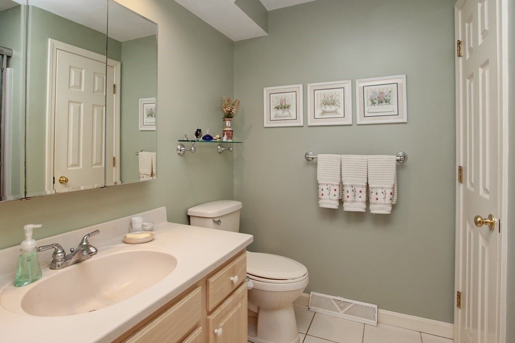 10 Kettle Lane, Unit 10 Mashpee, MA 02649 - Photo 14 of 31 a bathroom with a sink a toilet and mirror