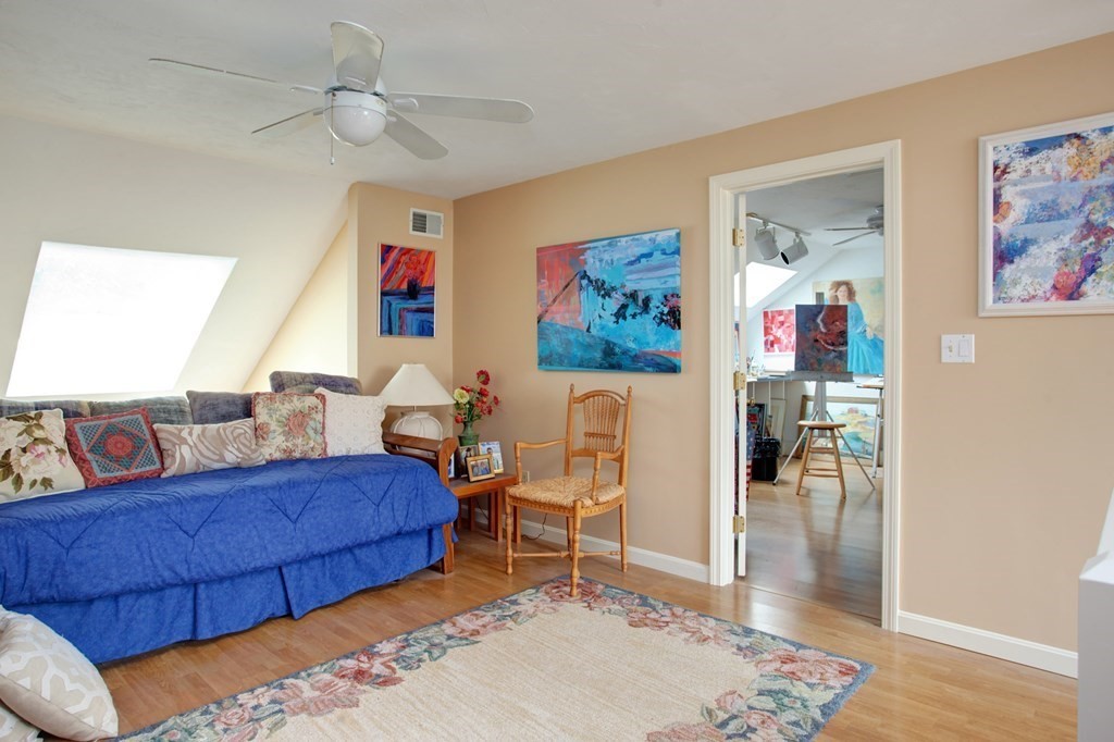 10 Kettle Lane, Unit 10 Mashpee, MA 02649 - Photo 16 of 31 a bedroom with furniture and a rug