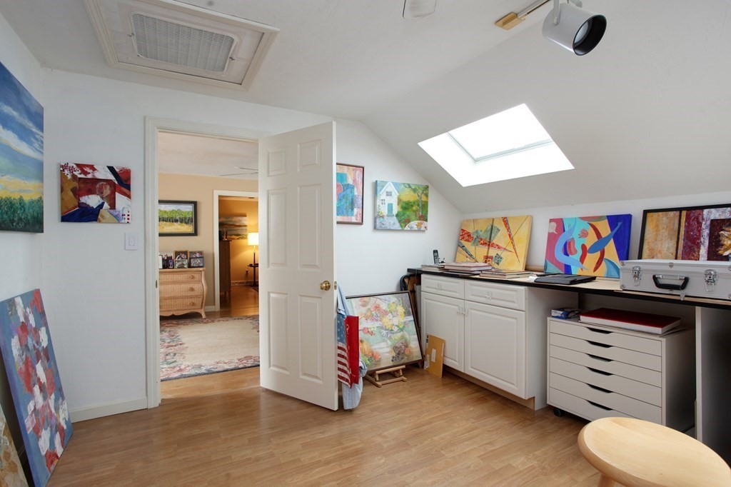 10 Kettle Lane, Unit 10 Mashpee, MA 02649 - Photo 18 of 31 a living room with furniture and a baby crib