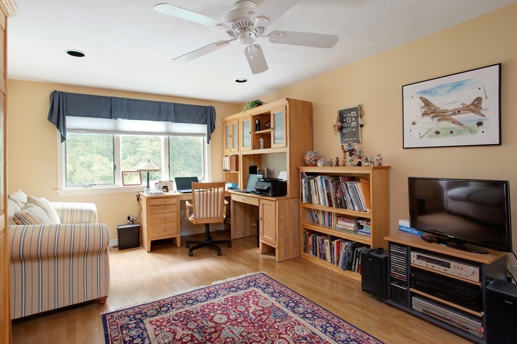 10 Kettle Lane, Unit 10 Mashpee, MA 02649 - Photo 20 of 31 a living room with furniture and a flat screen tv