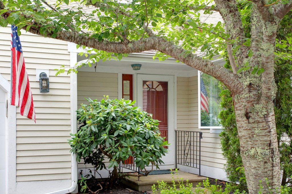 10 Kettle Lane, Unit 10 Mashpee, MA 02649 - Photo 2 of 31 a front view of a house with plants