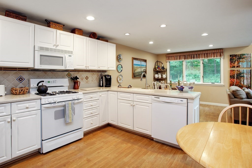 10 Kettle Lane, Unit 10 Mashpee, MA 02649 - Photo 8 of 31 a kitchen with sink refrigerator and microwave