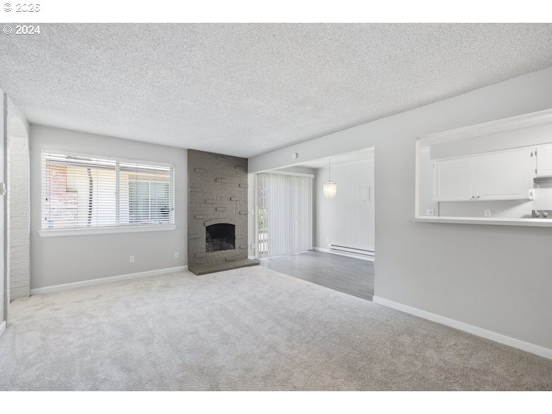 2921 Northeast Rene Avenue, Unit 15B Gresham, OR 97030 - Photo 17 of 22 a view of empty room with window and fireplace