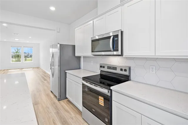 a kitchen with a stove microwave and refrigerator