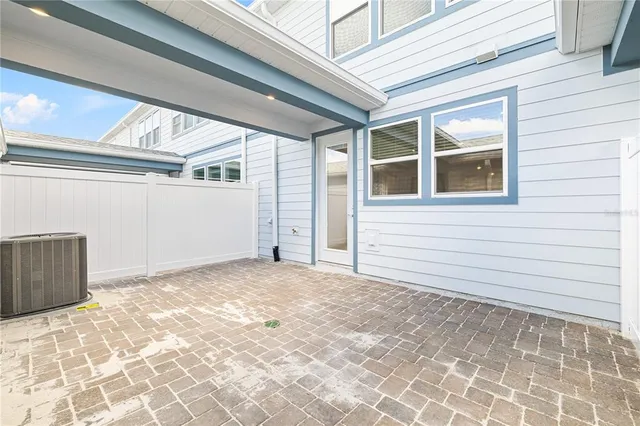 a view of a room with an empty space and a fireplace