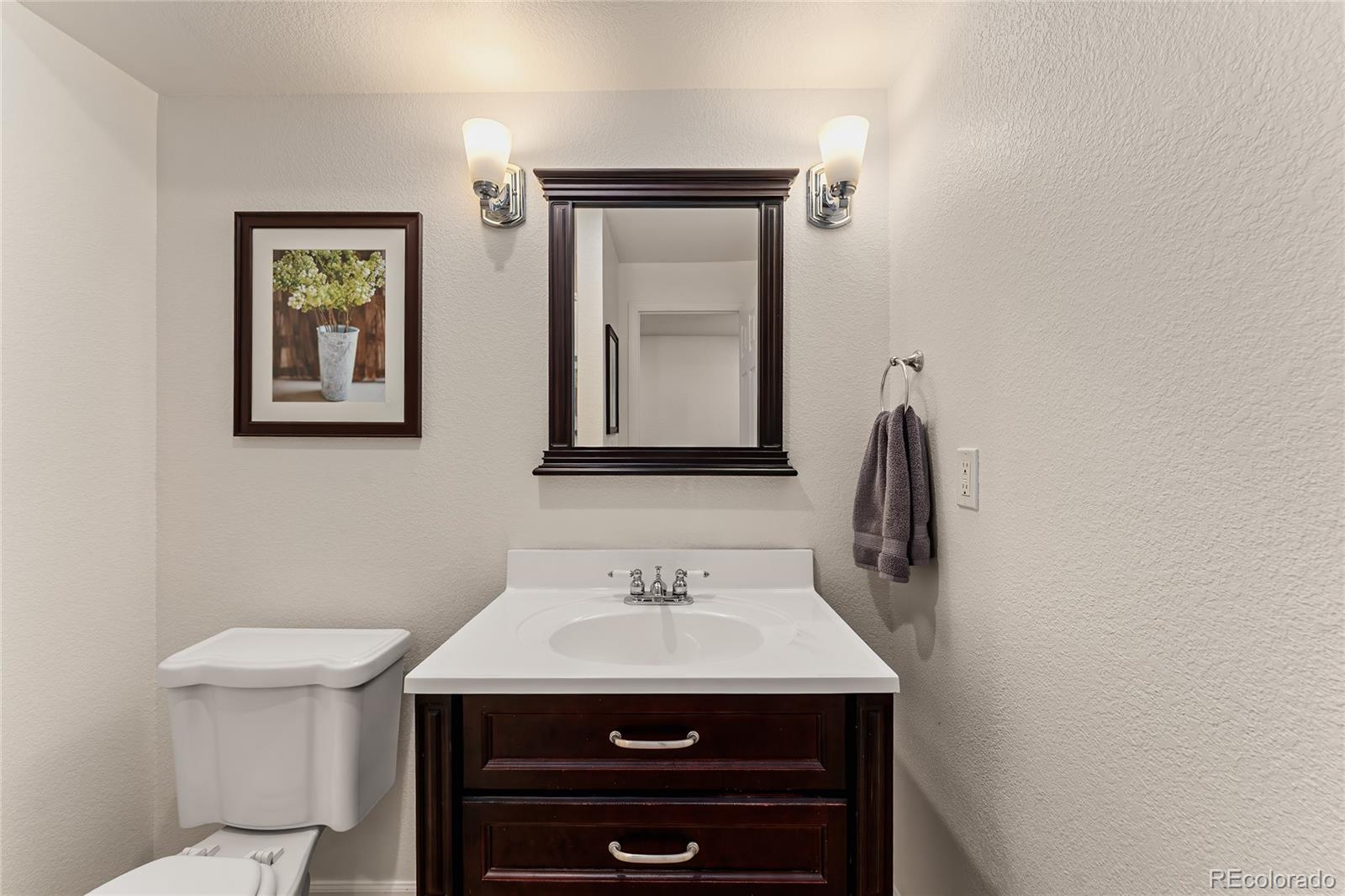 9441 South Hackberry Lane Highlands Ranch, CO 80129 - Photo 25 of 50 a bathroom with a sink and a mirror