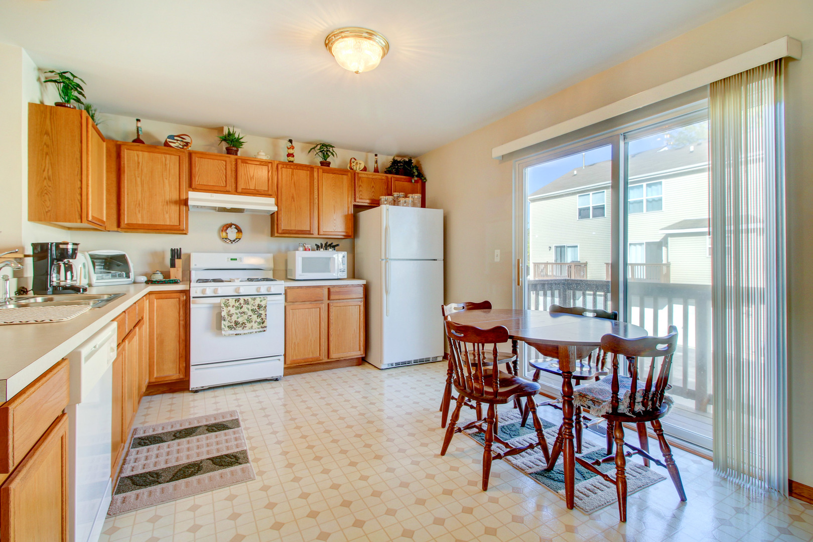 34295 North Barberry Road Round Lake, IL 60073 - Photo 11 of 23 a kitchen with a table chairs sink and cabinets