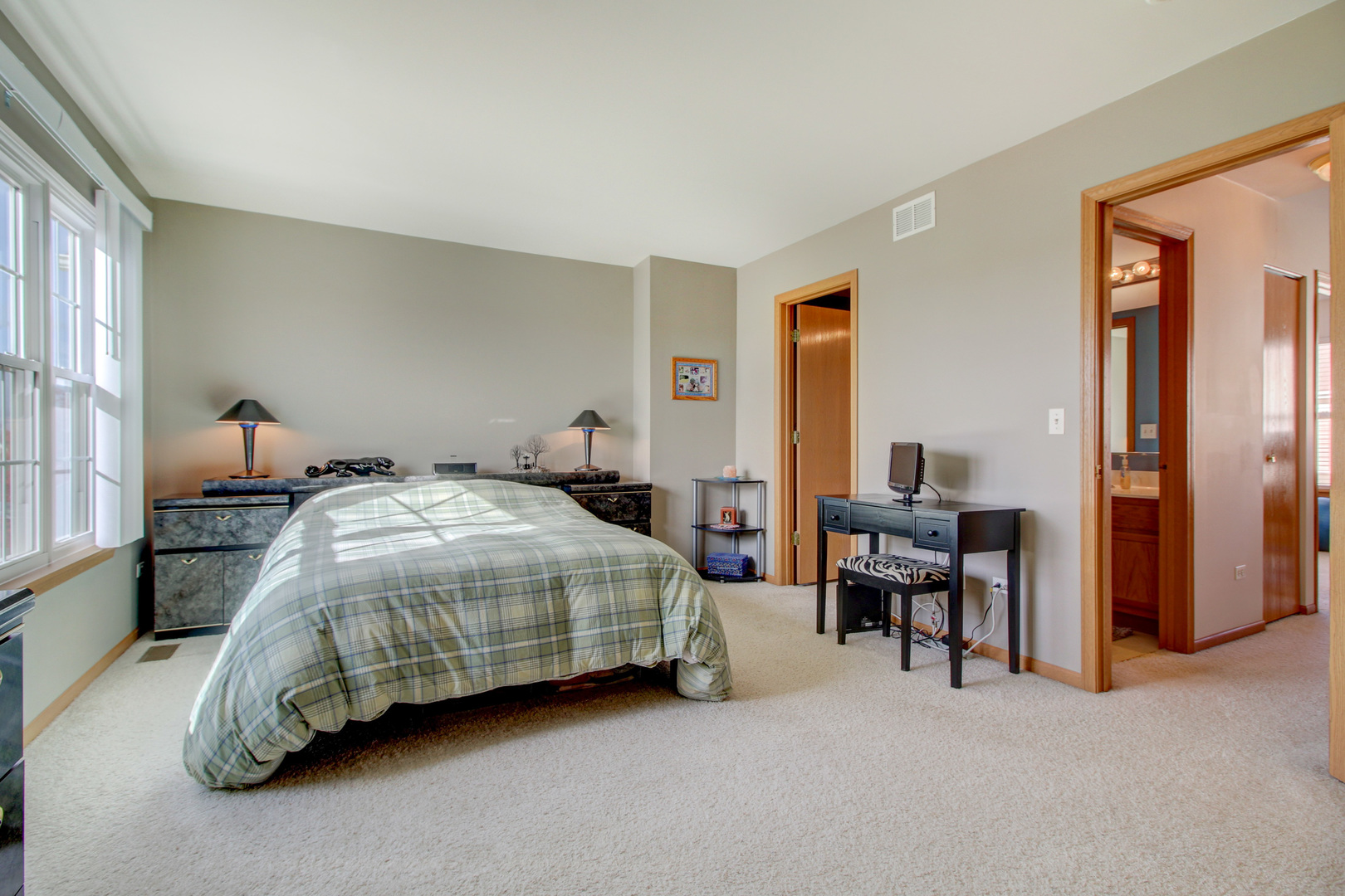 34295 North Barberry Road Round Lake, IL 60073 - Photo 21 of 23 a spacious bedroom with a bed and a table in it