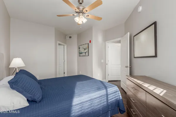a bedroom with a bed and a chandelier