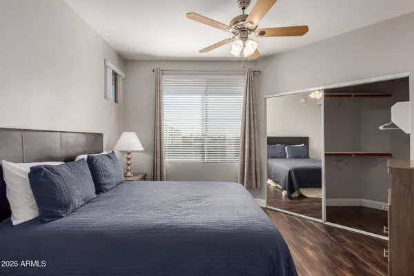 a bedroom with a large bed and a chandelier