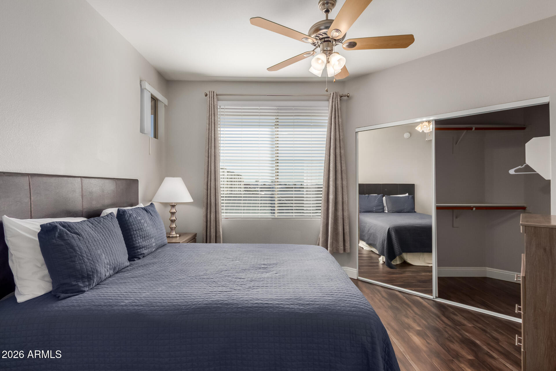 1701 East Colter Street, Unit 477 Phoenix, AZ 85016 - Photo 16 of 39 a bedroom with a large bed and a chandelier