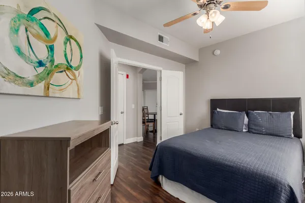 a bedroom with a bed and a chandelier