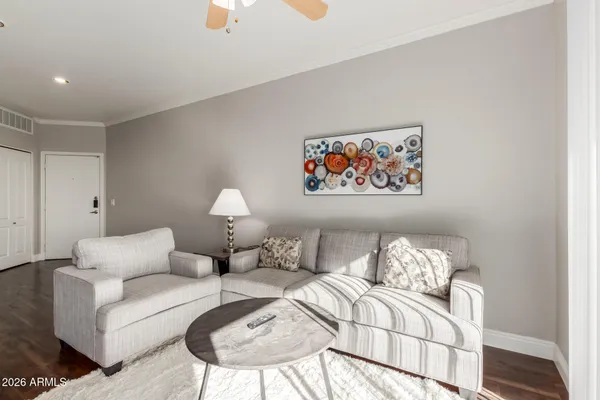 a living room with furniture a couch and a chandelier
